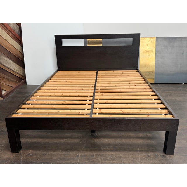 Design Plus Gallery presents the Queen Size West Elm Low Cut Out Bedframe. Constructed from wood in an espresso-brown...
