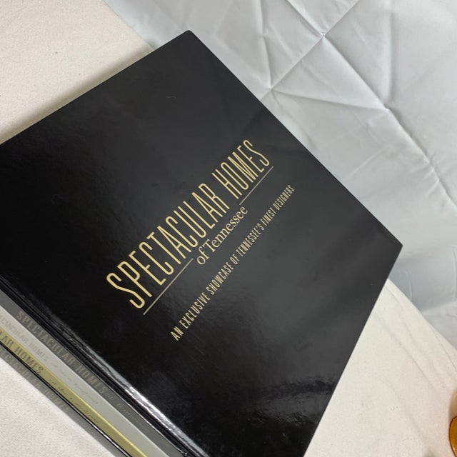 A stack of four large hardcover coffee table books from the Spectacular Homes series published by Panache Partners,...