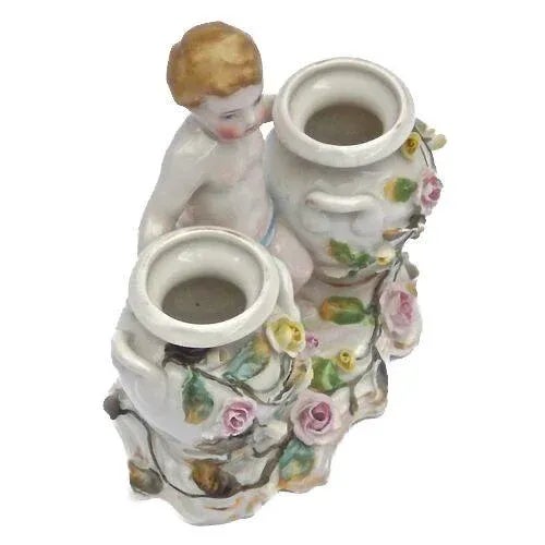 Antique Dresden porcelain cherub and floral double vase figurine with cherub figurine at the center flanked by small...