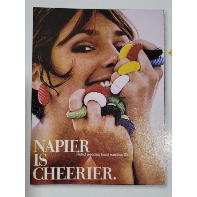 Goldtone yellow rectangular molded resin links with white resin connectors and fold over clasp. Marked "NAPIER©."...