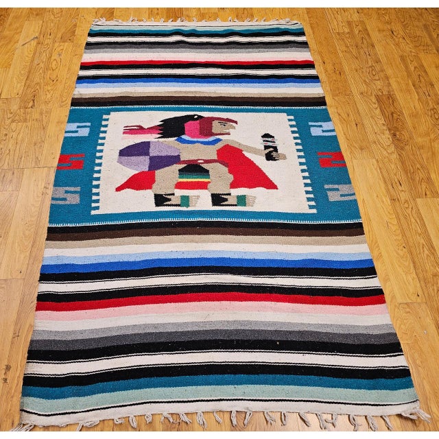 Bring bold artistry and cultural storytelling into your space with this vintage American Southwestern kilim area rug,...