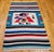 Bring bold artistry and cultural storytelling into your space with this vintage American Southwestern kilim area rug,...