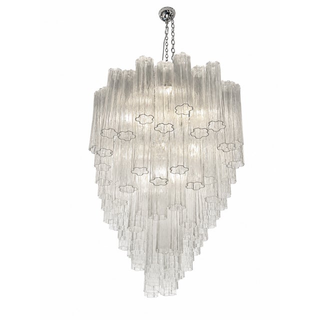 Scenographic italian hand-made chandelier with clear “tronchi”, elements of Murano glass. Huge chandelier in a bath of...