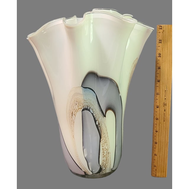 This beautiful vase is a true work of art. The hand-blown glass has been crafted with care and attention to detail,...
