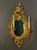 Stunning antique carved gilt girandole mirror in the Baroque manner with two candelabra, France, ca. 1890. An oval form,...