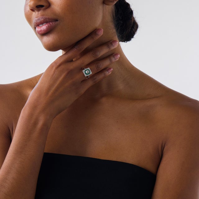 This beautiful Art Deco style diamond and emerald target ring brings together antique-inspired romance, vivid color, and...