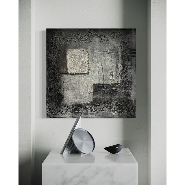 In Exit Strategy, J. Kent Martin explores a moody, textural composition of layered charcoal, slate gray, and muted white,...