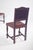 Set of eight chairs with backs and seats in studded leather. Two of the chairs have armrests, the structure is made of...