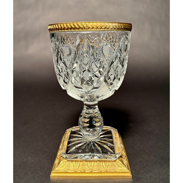 A refined French cut crystal compote mounted in gilt bronze (ormolu), marked “Made in France,” executed in a Neoclassical...