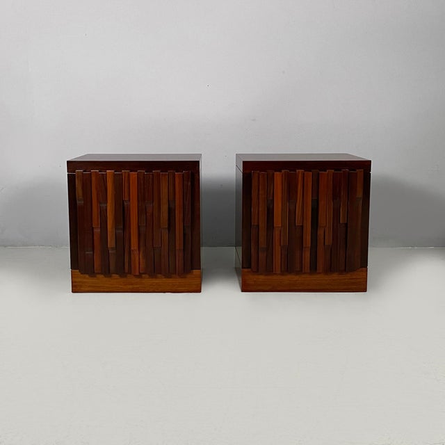 Italian modern wood bedside tables, 1970s Pair of Norman bedside tables with a rectangular base in dark wood. The front...