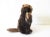 A vintage Steiff beaver, with dark brown and white plush fur, a brown velvet tail and paw pads, glass eyes, and felt...
