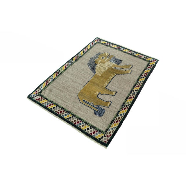 An exceptional hand-knotted Gabbeh nomad rug measuring 156 x 110 cm. The impressive lion motif gives this rug a powerful...