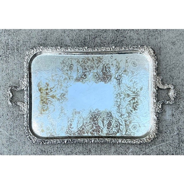 This magnificent vintage silver plate serving tray exudes traditional elegance and timeless sophistication. Adorned with...