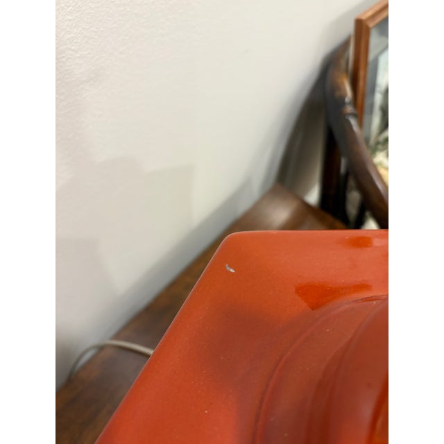 Substantial ceramic lamp in a hexagonal shape and rust orange color. Recently rewired. Excellent condition. Nice bracket...