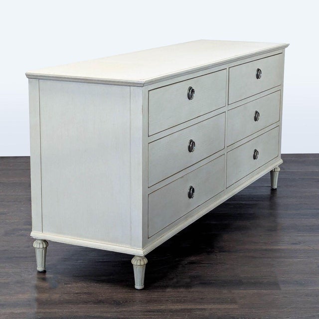 This Restoration Hardware dresser features a classic antique white finish and six spacious drawers with elegant metal ring...