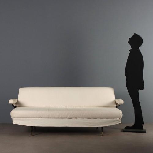 Vintage sofa bed with enameled metal frame, brass feet, foam padding and white fabric upholstery. This piece is attributed...