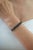 The Wide Three-Row Mosaic 14.37 CTW Black Onyx Tennis Bracelet features 14.37 carats of Black Onyx arranged in three rows...