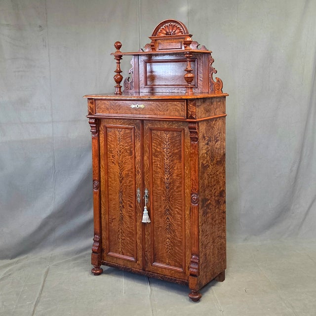 An exceptional antique German Wilhelmenian style tall buffet sideboard handcrafted in the late 1800s out of stunning flame...
