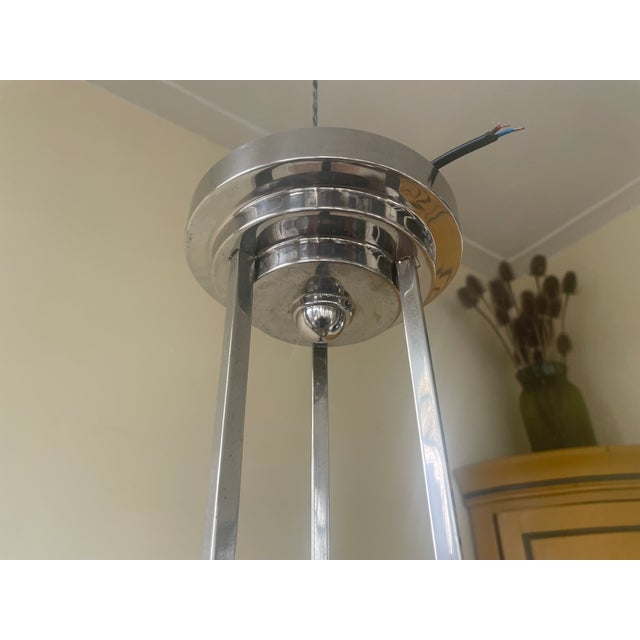 A stunning pendant lamp from the French Art Deco period of 1930. This beautiful lamp has three arms with light fittings...