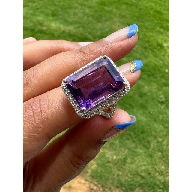 This is part of Chairish’s Fine Jewelry assortment. 13.33 Carat Large Octagon Amethyst and Diamond Cocktail Ring in 14K...