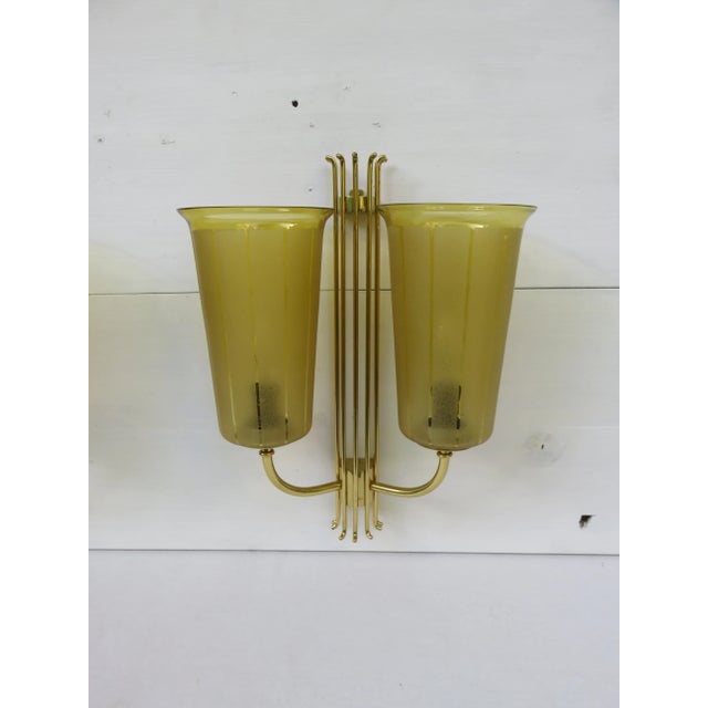 Elegant large wall lights from the 50 years of brass The hand-blown glass has the typical bubble inclusions. By rotating...