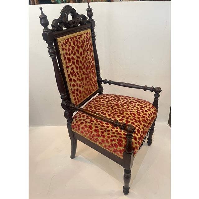 This piece is a diminutive Napoleon II Gothic Revival accent armchair, popular during the mid-to-late 19th century...