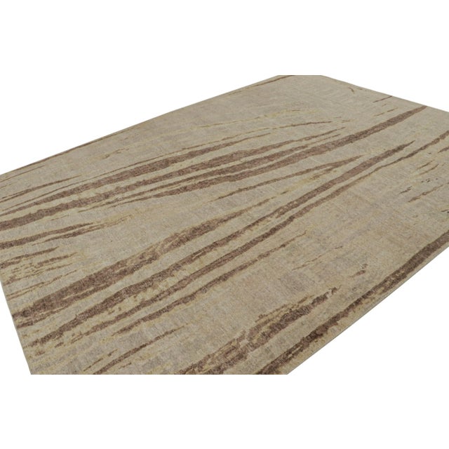 Hand-knotted in wool, this 9x12 modern rug, originating from India, as inspired by modern art with a take on abstract...