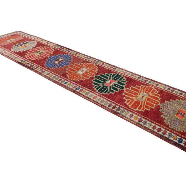Hand knotted in wool originating from Turkey circa 1950-1960, this vintage runner enjoys a distinctively rich, tastefully...