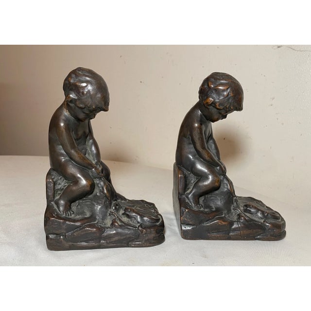 Up for sale is a wonderful pair of antique 19th century figural bronze clad nude cherub bookends. Each is in the form of a...