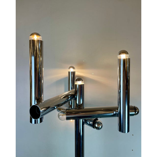 A striking and sculptural floor lamp made of chromed metal tubes with 10 light bulbs. Design attributed, or in the style...
