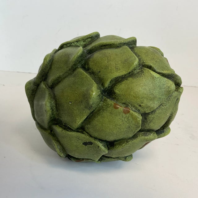 We love the gorgeous green color of this decorative Artichoke. It’s a tabletop decorative object that’s colorful and has...