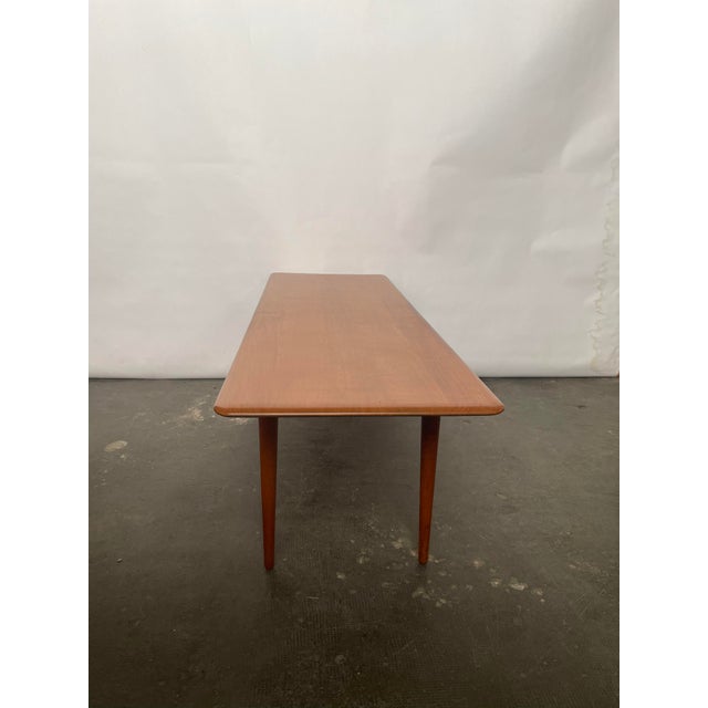 This model FD516 teak coffee table was designed by Peter Hvidt & Orla molgaard for France and Søn. This piece has an...