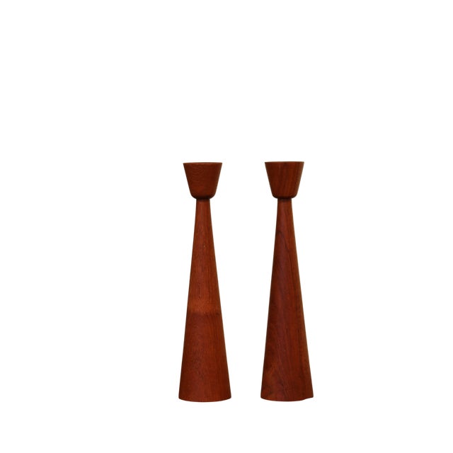 The pair of candle holders in solid teak with a soft yet classic cut. This piece has an attribution mark, I am sure that...