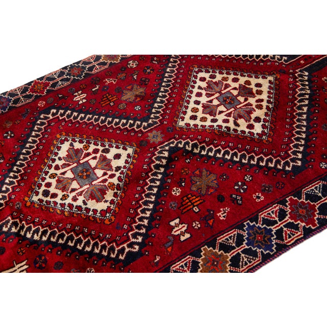 Vintage Persian Hand-Knotted Wool Rug Featuring a Red Field and a Tribal Design For Sale - Image 4 of 10