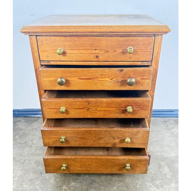 A charming and honest early 20th-century pine chest of drawers, full of character and warm, sun-washed patina. The piece...