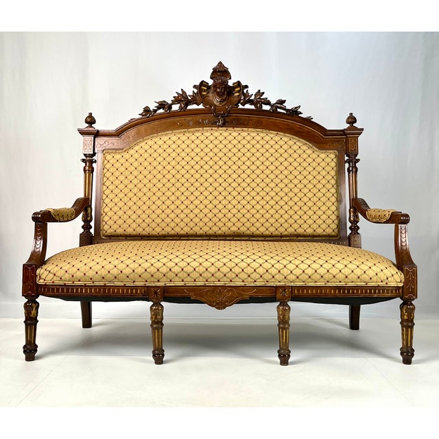 A grand, late 19th-century Italian Renaissance Revival three-piece parlor set, comprising a three-seat settee and two...
