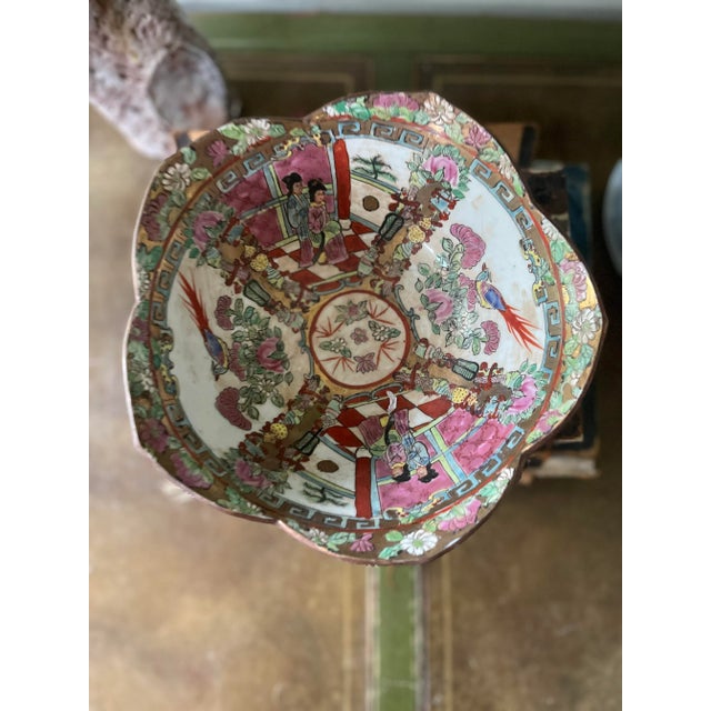 Stunning Asian ceramic bowl, presented in a timeless and historic pattern of famille rose. Around the interior and...