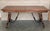 A monumental 20th century Spanish trestle table, having a rectangular framed solid walnut board top, resting on hand...
