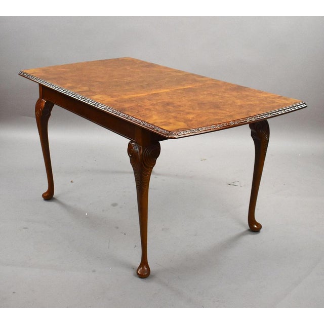 Elegant mid-century walnut dining suite comprising an extendable dining table with one leaf, six matching chairs, and a...