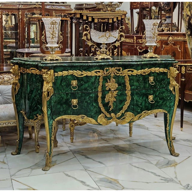 Make an unforgettable statement with this extraordinary French-inspired commode, featuring a rich bottle-green marble-...