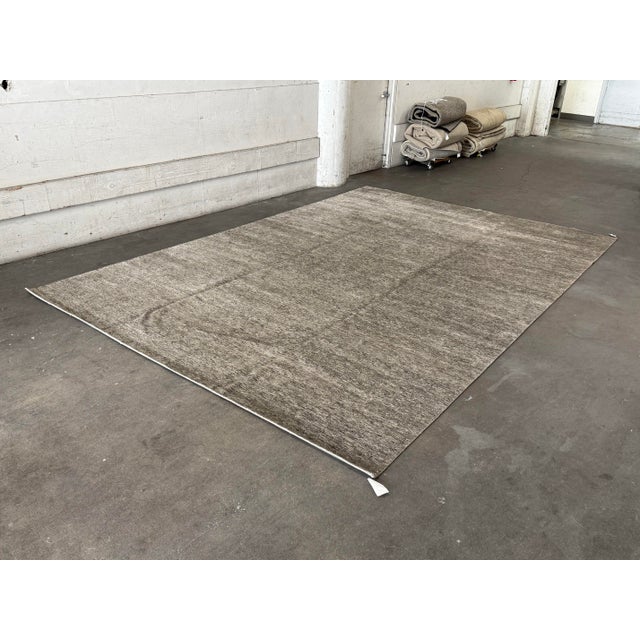Design Plus Gallery presents a 9ft x 12ft modern area rug by Artisan Rugs. The rug showcases an understated abstract...