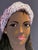 Caribbean folk art figurative portrait of a woman surrounded by a dense field of multicolored flowers in pink, blue,...