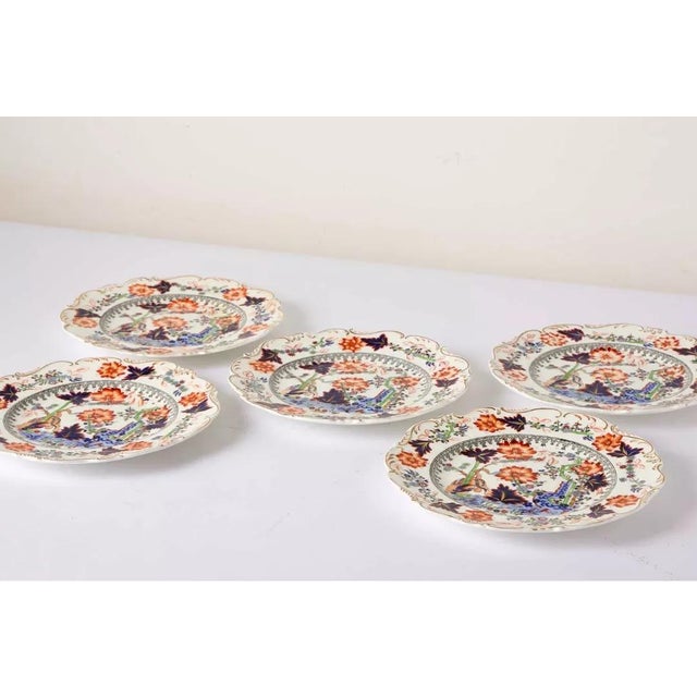Five english stoneware plates in the japanese style 'kakiemon tiger' pattern mid-19th century, the foliated edges with...