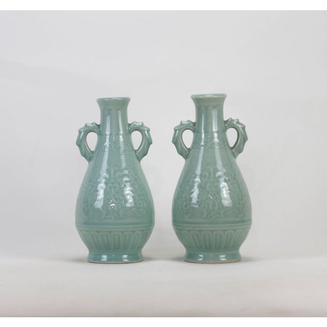 A pair of 20th-century celadon vases with handles