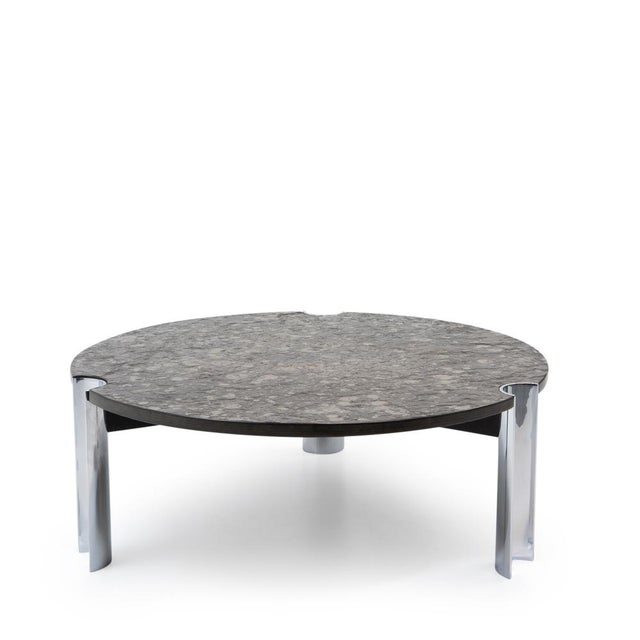 Round, heavy coffee table dating from the 1970s and featuring a polished chrome steel base paired with a textured...