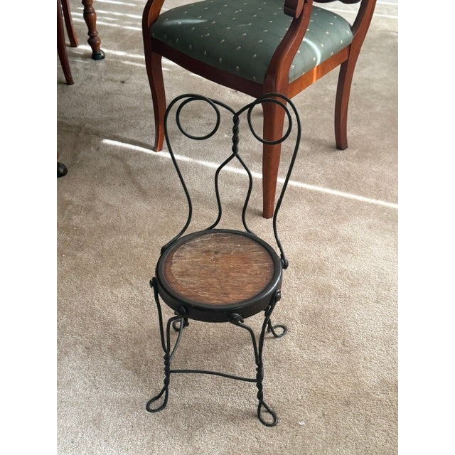 This child size ice cream parlor chair features a twisted iron wire frame with a heart shaped backrest and a round seat...