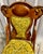 Intricate carvings on this chair’s backrest are a hallmark of Victorian furniture, reflecting the era’s appreciation for...