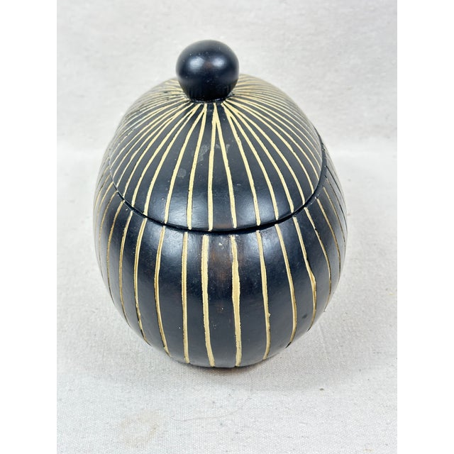 Lovely vintage lidded box. In the shape of an oval. Black and a creamy white color. Bottom has felt to protect surfaces....