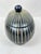 Lovely vintage lidded box. In the shape of an oval. Black and a creamy white color. Bottom has felt to protect surfaces....