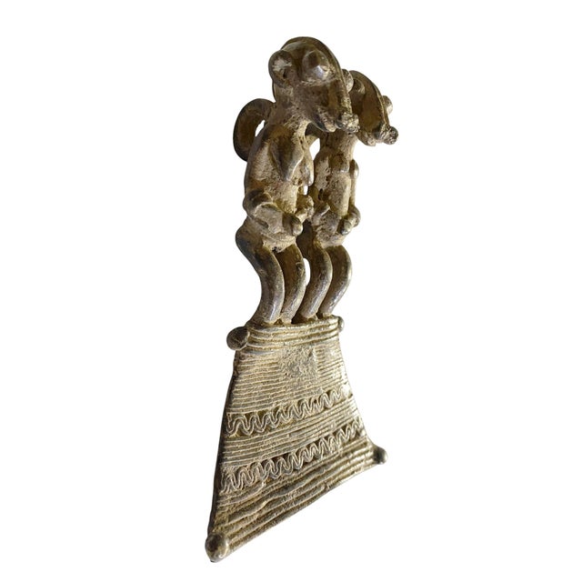 A vintage Lobi bronze pendant / Burkina Faso, made through the lost-wax casting process. This amulet depicts a standing...